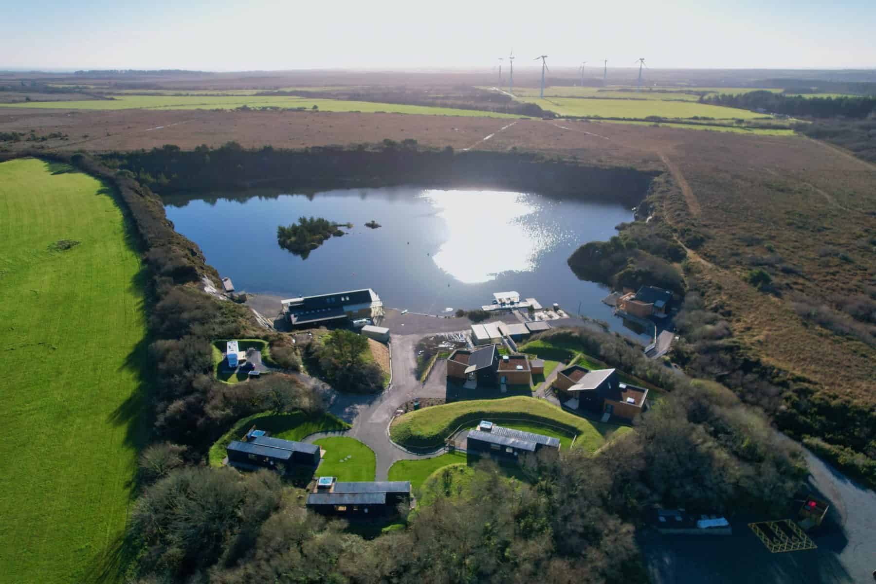 Aerial view of Trevassack lake and the holiday cottages in Cornwall