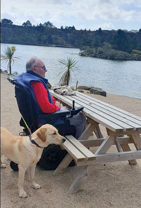Wheelchair user David with dog Toby on Trevassack Lake beach