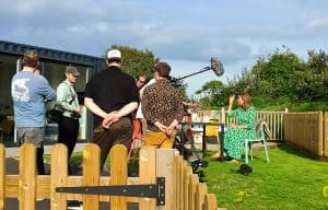 Channel 5 film crew in the garden of Calcite Cabin, filming Amanda Lamb.